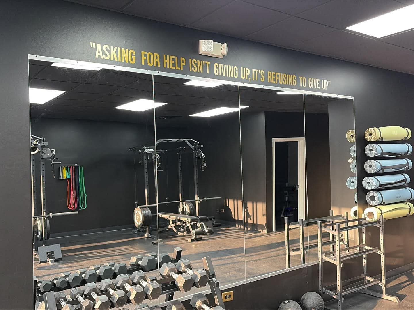 Dumbbell rack, kettlebells, and mobility mats at Odyssey Strength & Recovery